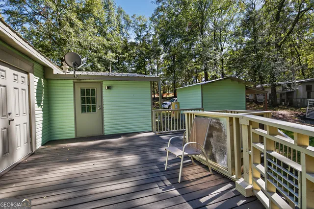 a view of a chair and tables in the balcony