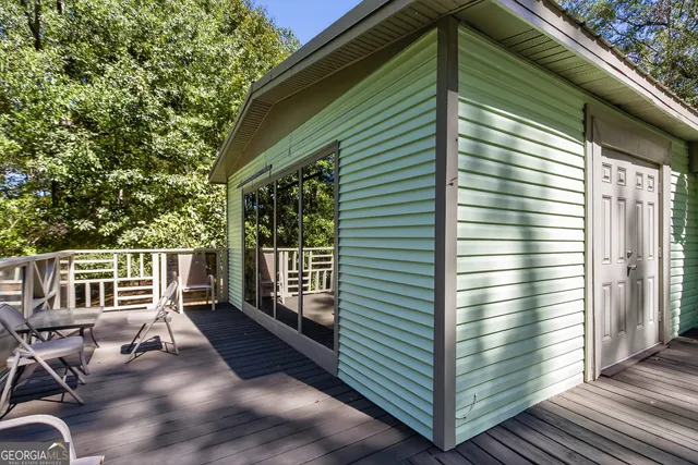 a view of a porch with wooden floor and fence