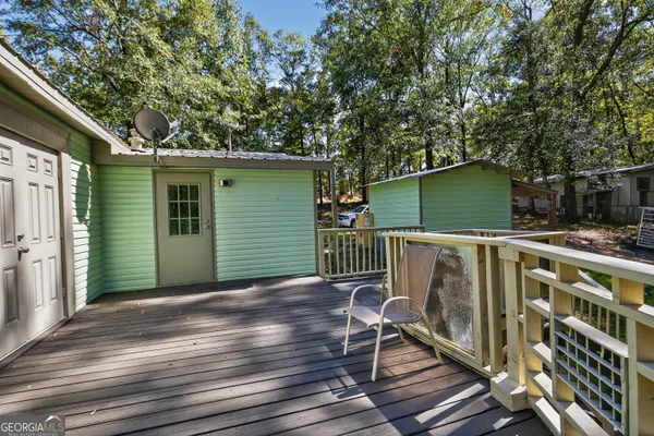 a view of a porch with wooden floor and fence