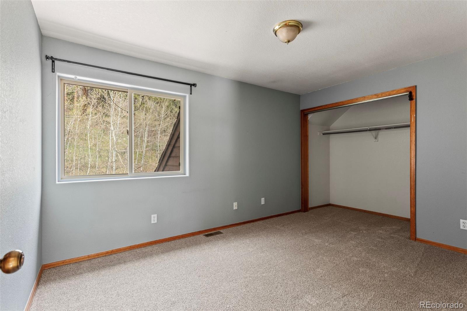 12183 Arnett Ranch Road Littleton, CO 80127 - Photo 20 of 28 a view of an empty room with a window