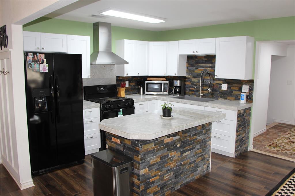 800 Griffin Road Albany, TX 76430 - Photo 3 of 15 a kitchen with stainless steel appliances granite countertop a sink a stove and refrigerator