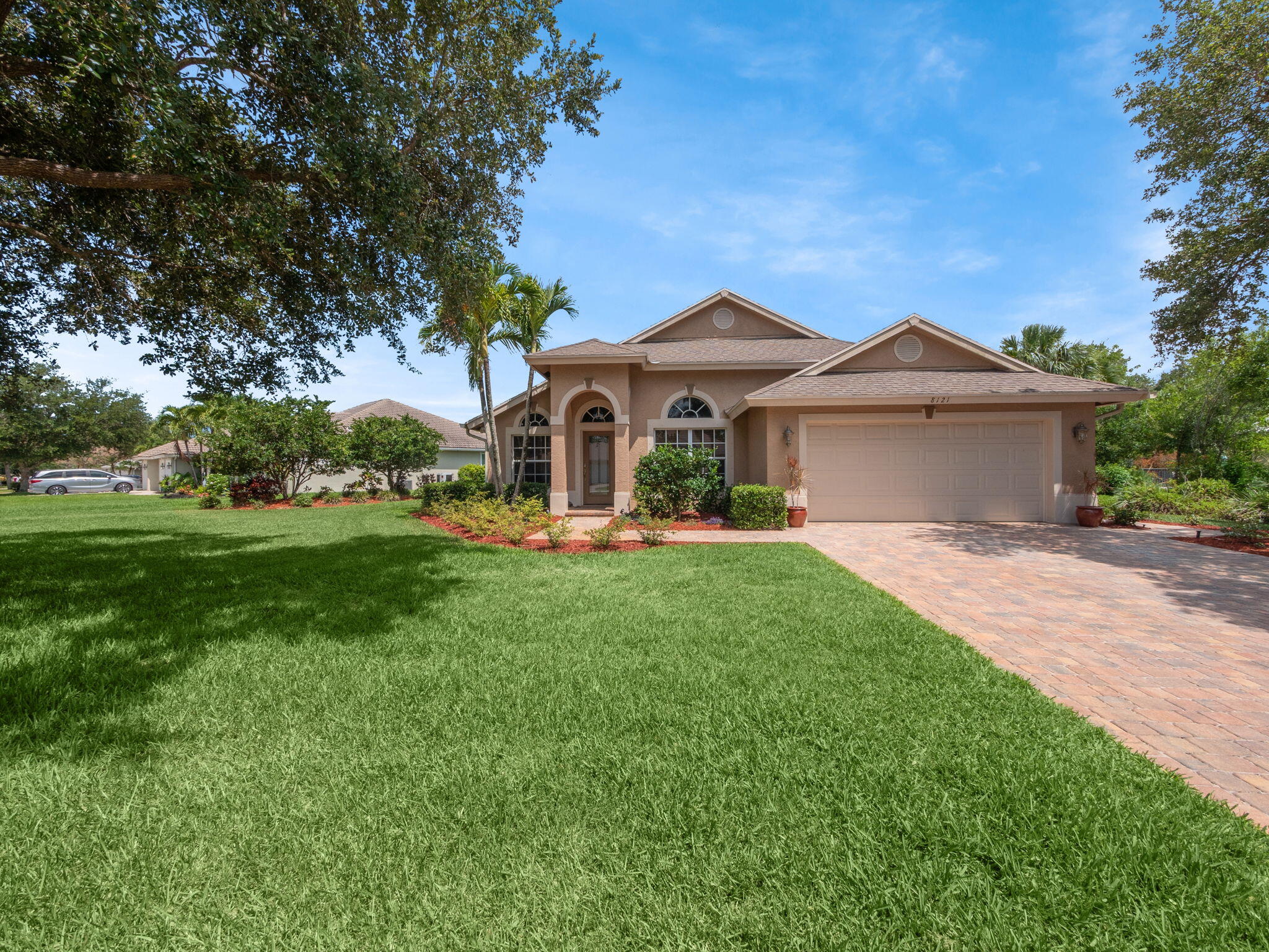 8121 Southwest Yachtsmans Drive Stuart, FL 34997 - Photo 1 of 28 a front view of a house with garden