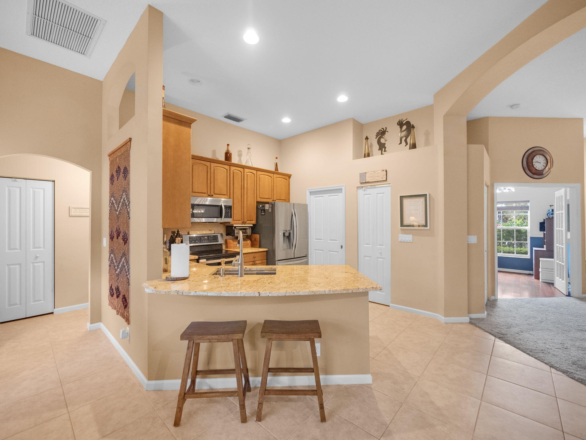 8121 Southwest Yachtsmans Drive Stuart, FL 34997 - Photo 11 of 28 a dining hall with stainless steel appliances a dining table and chairs