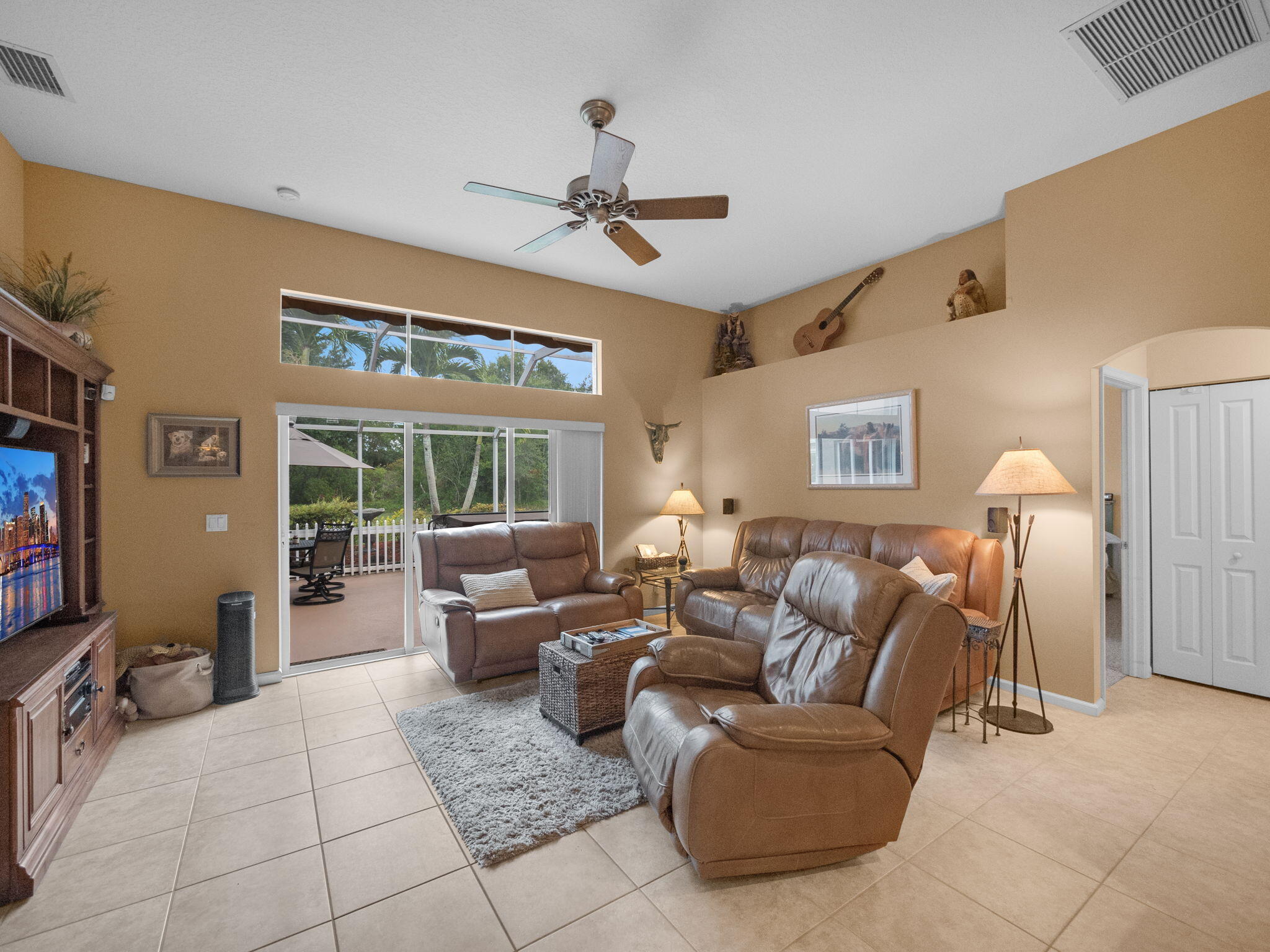 8121 Southwest Yachtsmans Drive Stuart, FL 34997 - Photo 13 of 28 a living room with furniture two window and a flat screen tv