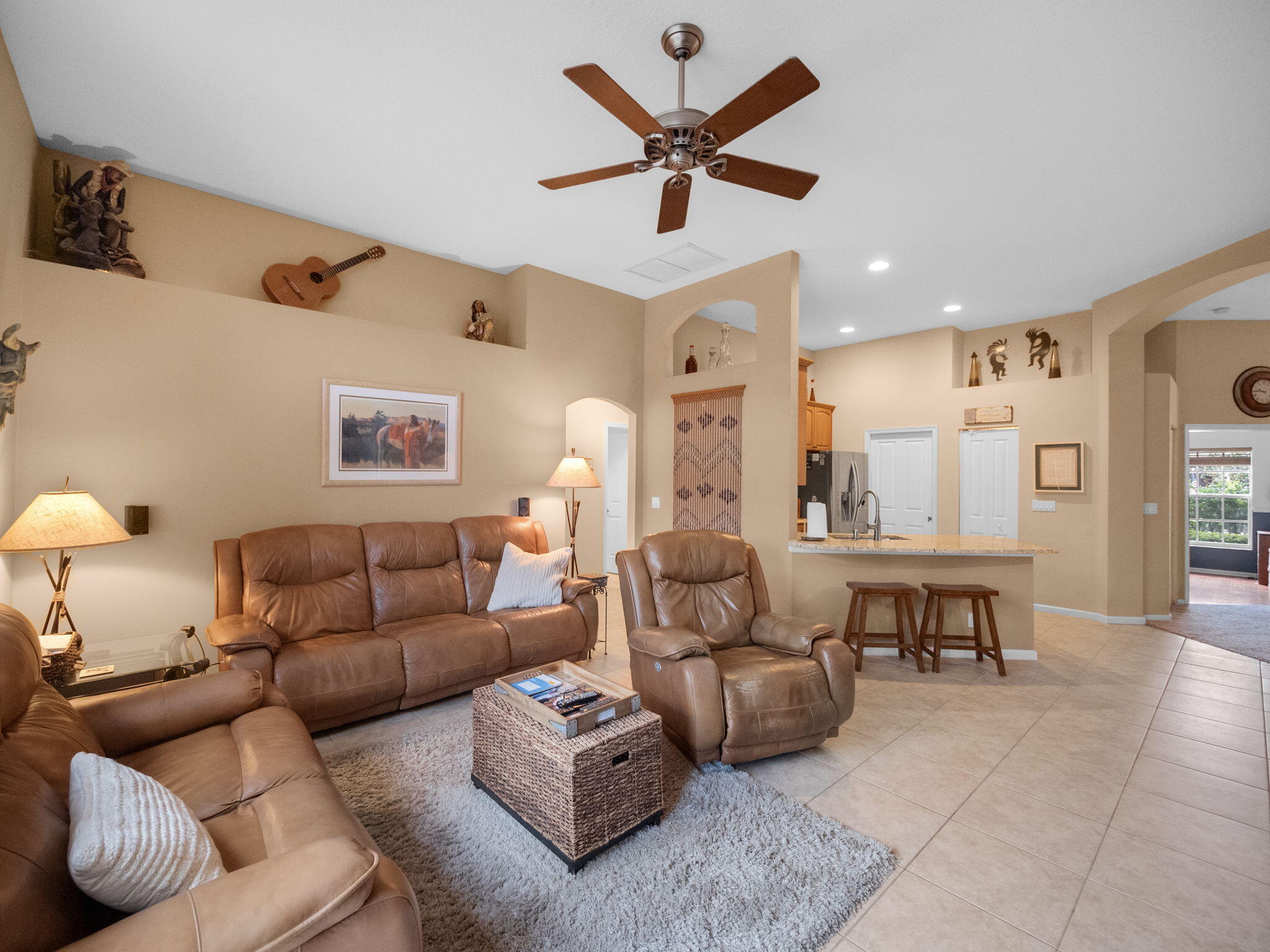 8121 Southwest Yachtsmans Drive Stuart, FL 34997 - Photo 14 of 28 a living room with furniture and a view of kitchen