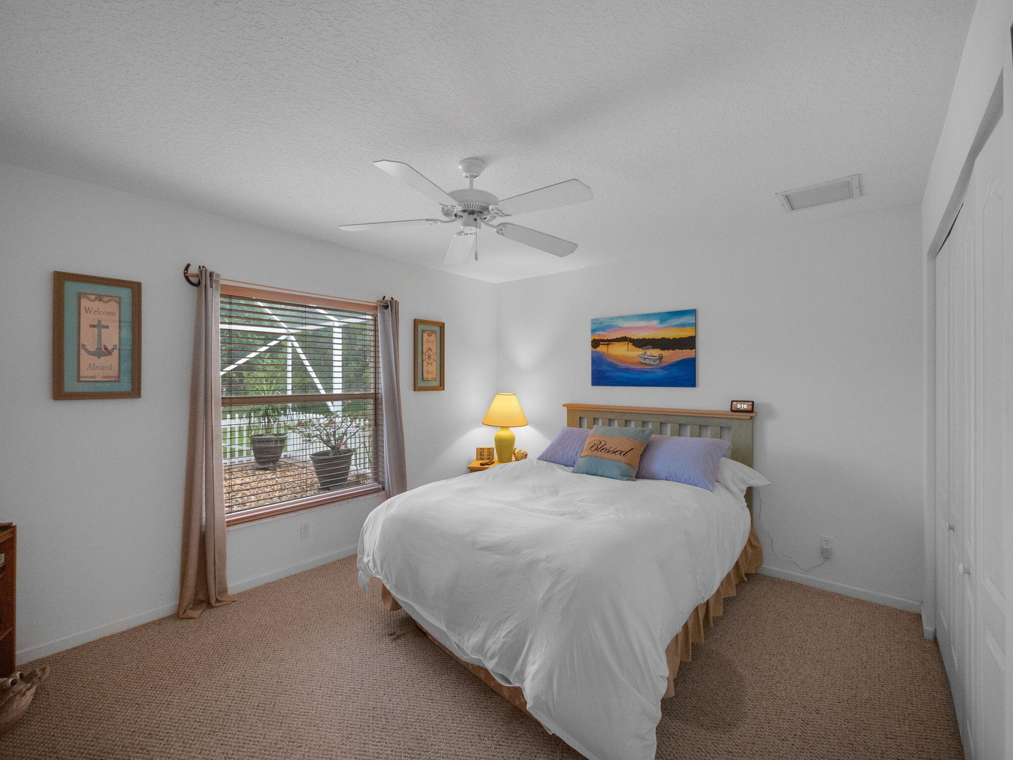 8121 Southwest Yachtsmans Drive Stuart, FL 34997 - Photo 20 of 28 a bedroom with a bed and a painting on the wall