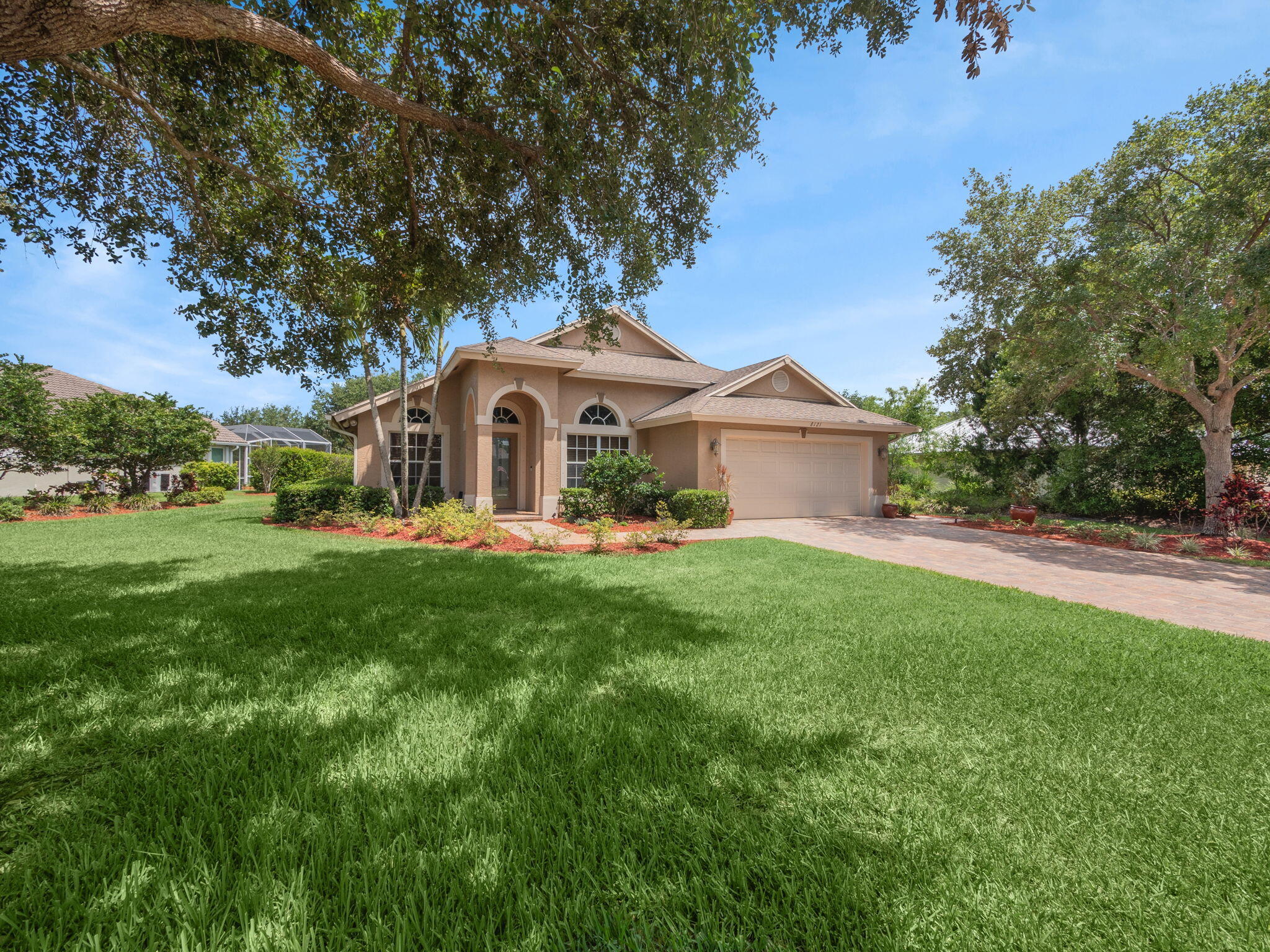8121 Southwest Yachtsmans Drive Stuart, FL 34997 - Photo 2 of 28 a front view of a house with garden