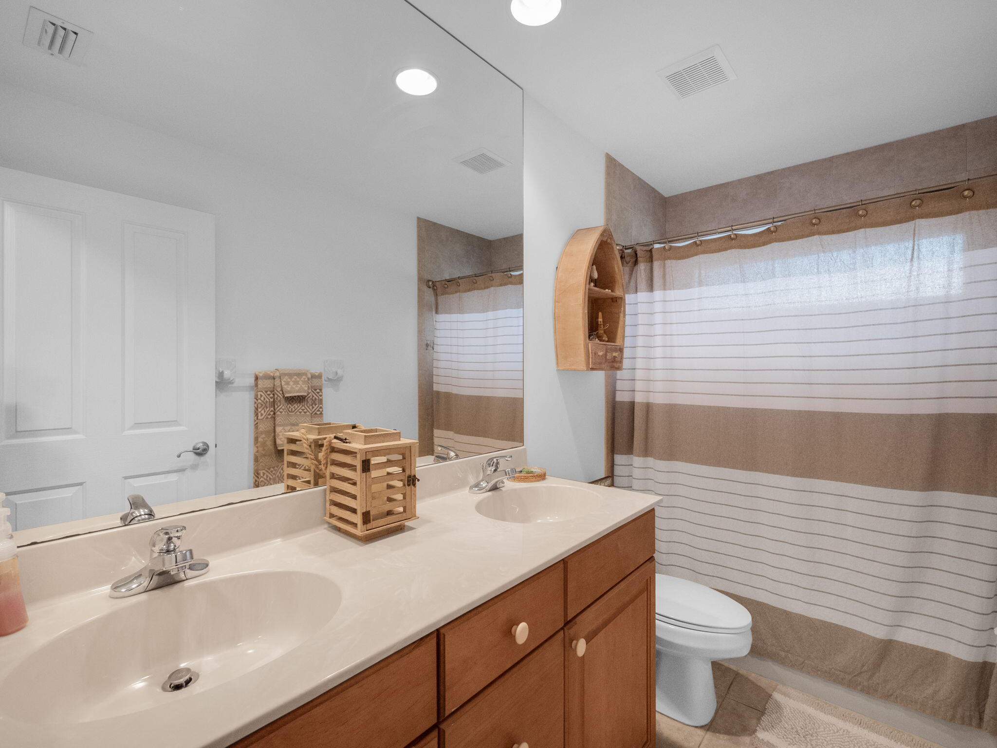 8121 Southwest Yachtsmans Drive Stuart, FL 34997 - Photo 21 of 28 a bathroom with a double vanity sink toilet and shower