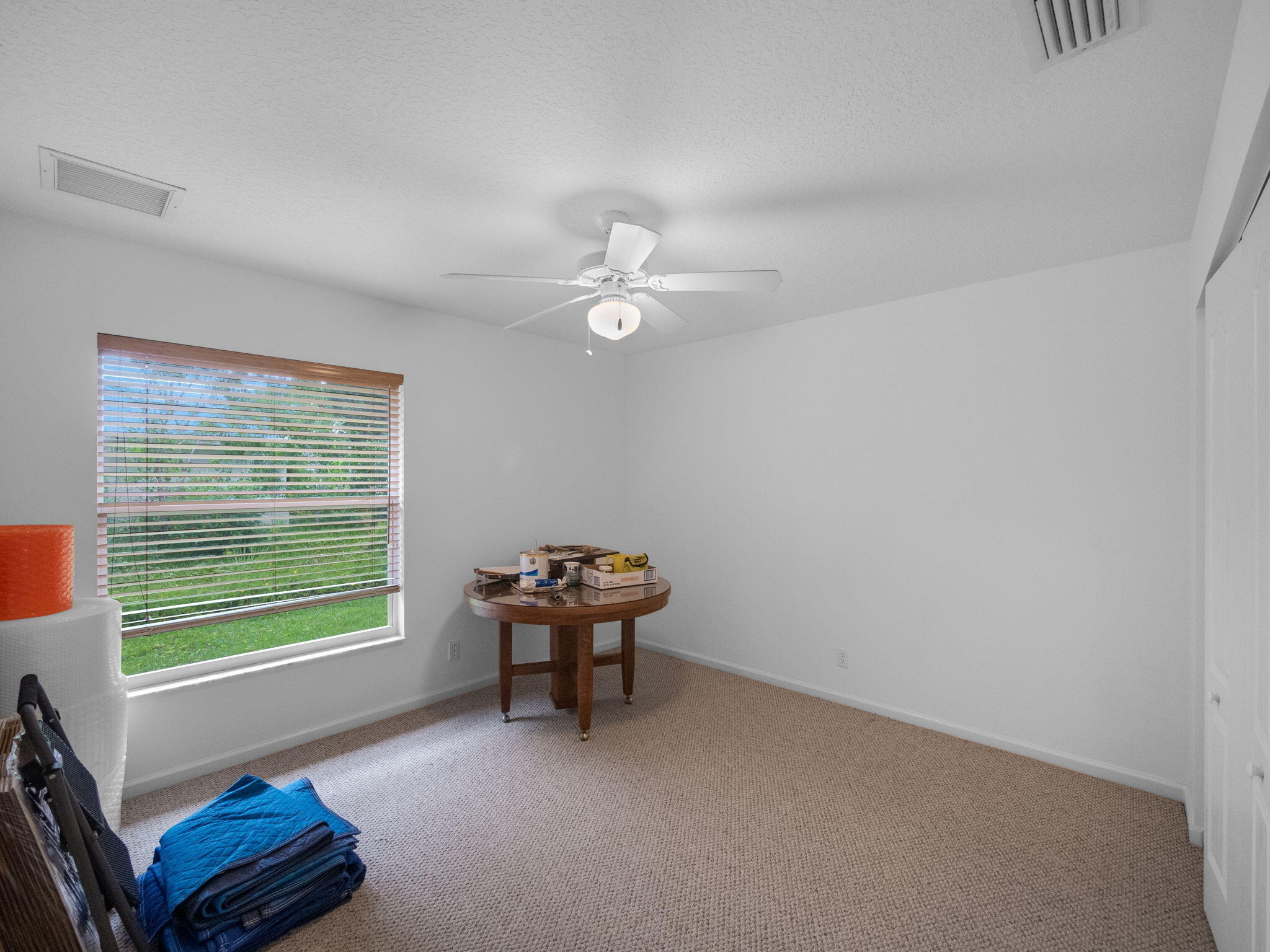 8121 Southwest Yachtsmans Drive Stuart, FL 34997 - Photo 22 of 28 a living room with furniture and a window