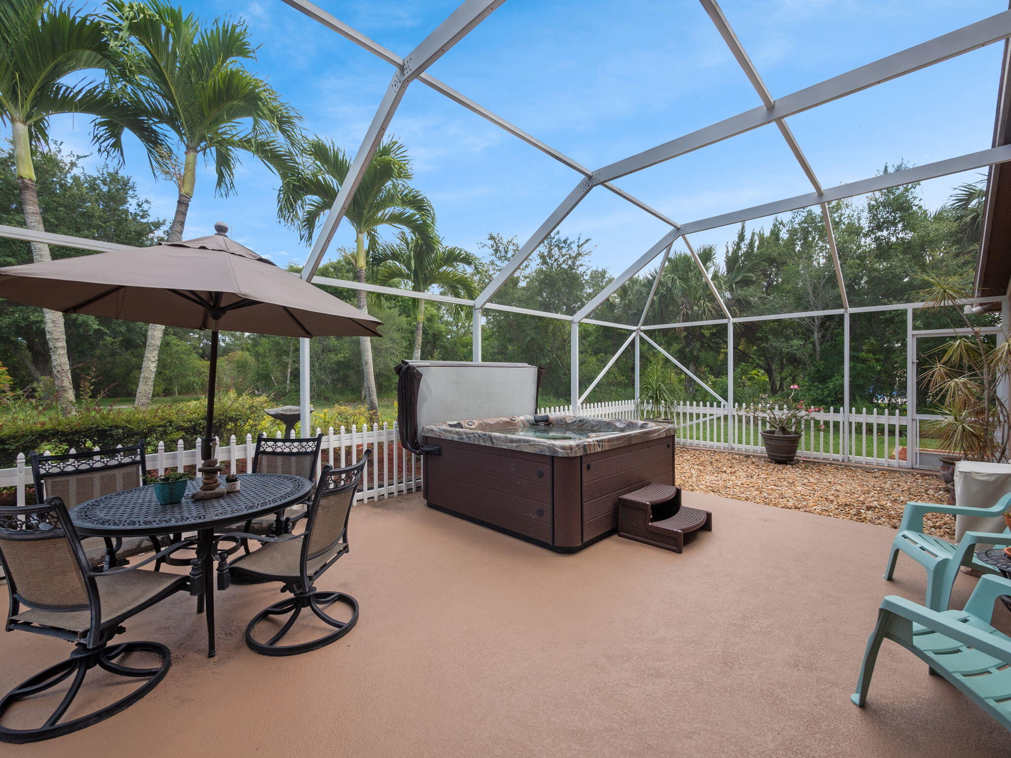 8121 Southwest Yachtsmans Drive Stuart, FL 34997 - Photo 26 of 28 a view of a chairs and table in the back yard