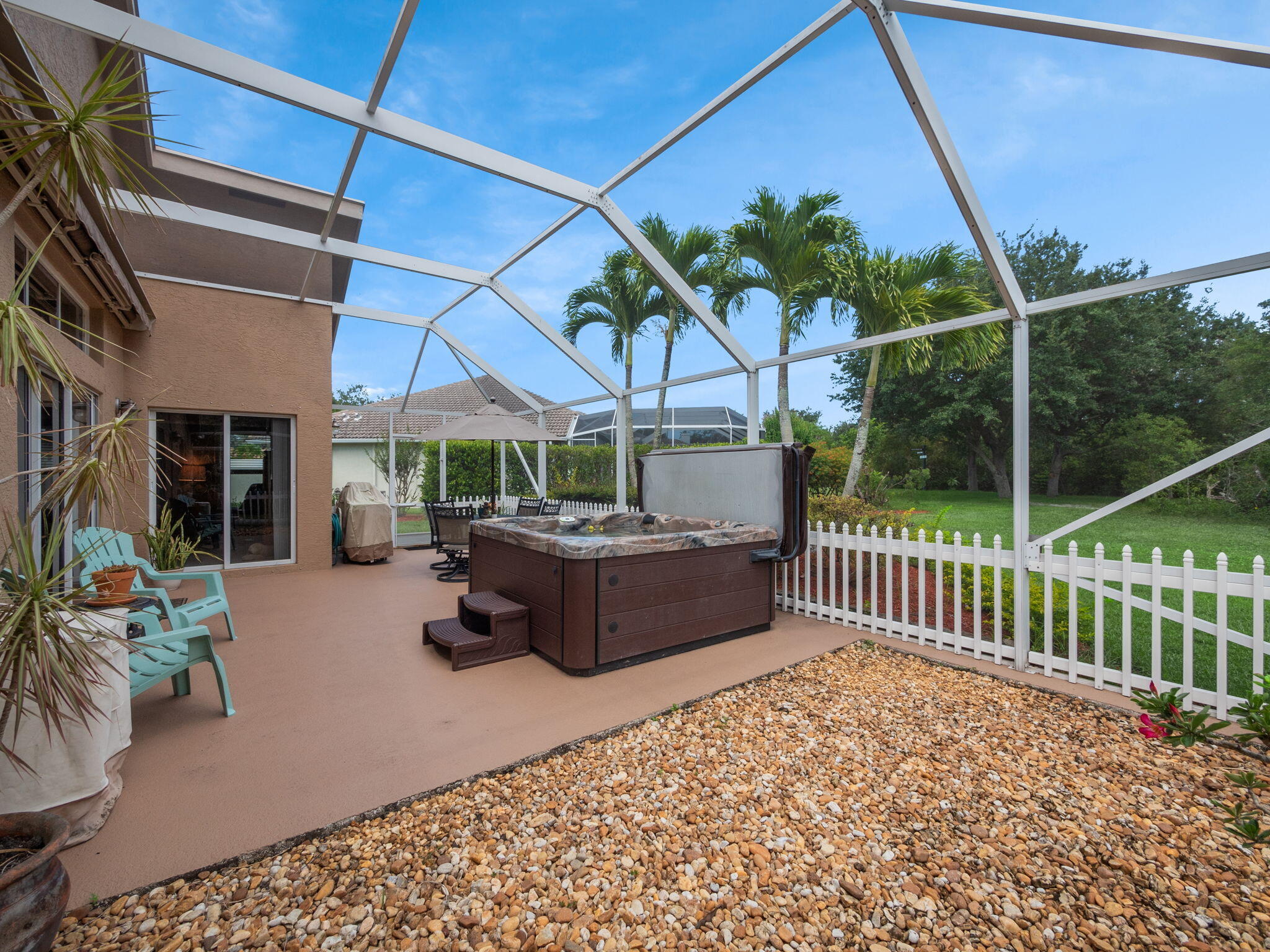8121 Southwest Yachtsmans Drive Stuart, FL 34997 - Photo 27 of 28 a view of a patio with a table chairs and a potted plant