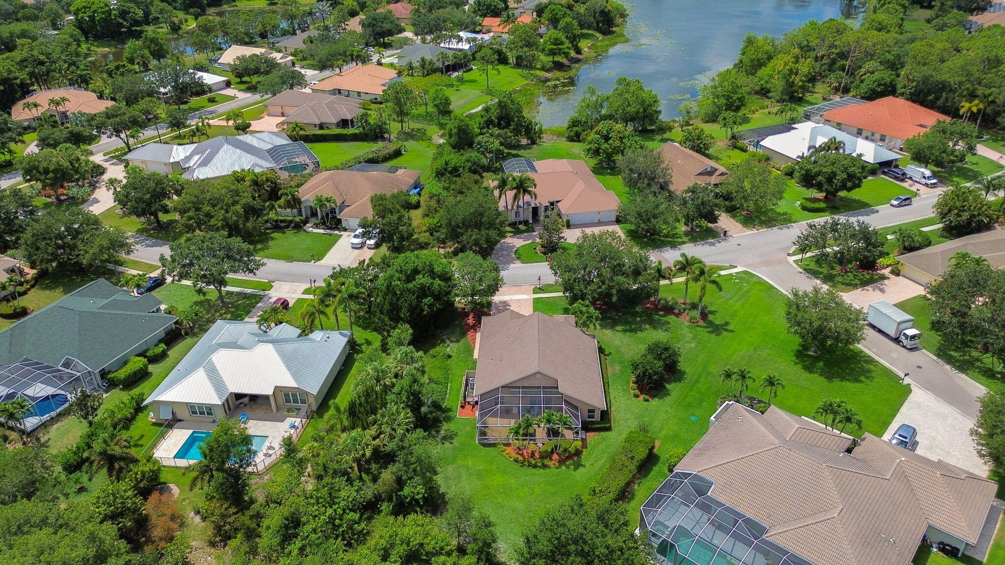 8121 Southwest Yachtsmans Drive Stuart, FL 34997 - Photo 4 of 28 an aerial view of a house with a yard and lake view