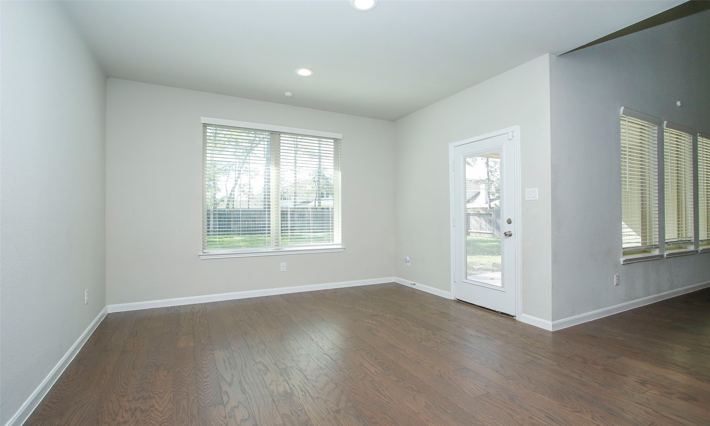 14120 Sand Ridge Court Conroe, TX 77384 - Photo 19 of 43 an empty room with wooden floor and windows