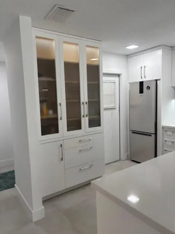 a kitchen with cabinets and stainless steel appliances
