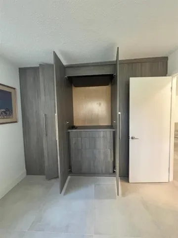 a view of a porch with a table and chairs