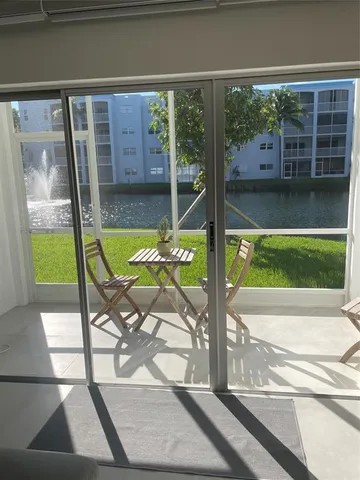 a lobby with furniture and floor to ceiling window
