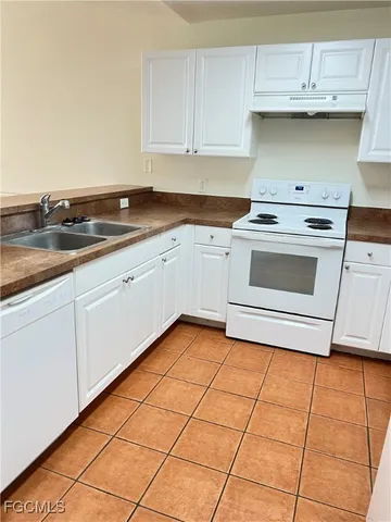a kitchen with granite countertop a sink and a stove