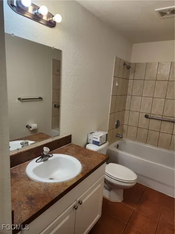 a bathroom with a sink toilet vanity and shower