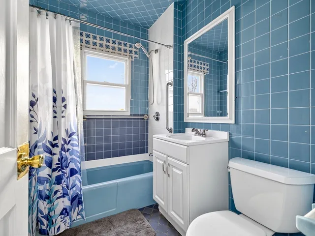 a bathroom with a toilet a sink and bathtub