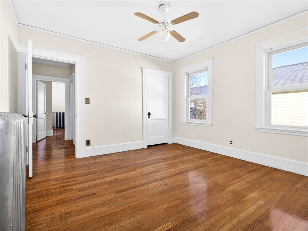 104 Greaton Road Boston, MA 02132 - Photo 24 of 42 a view of empty room with wooden floor and fan