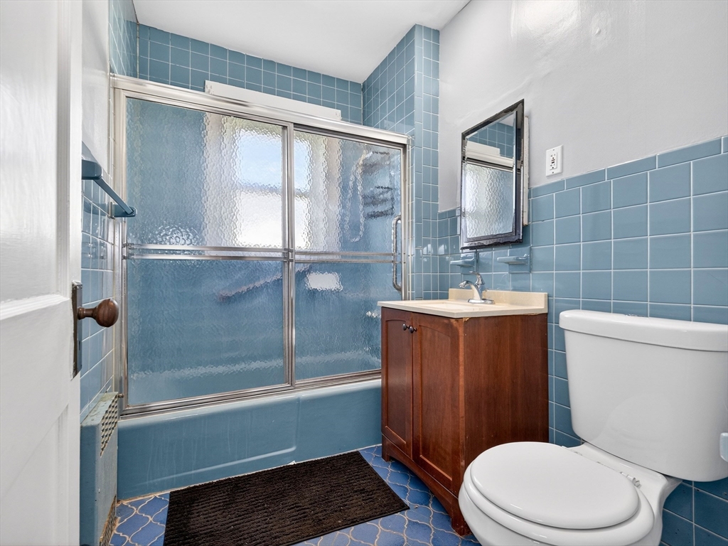 104 Greaton Road Boston, MA 02132 - Photo 27 of 42 a bathroom with a sink a toilet a mirror and shower