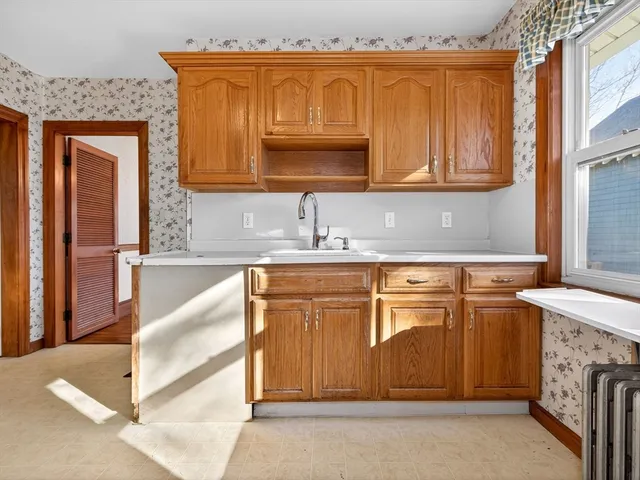 a kitchen with stainless steel appliances granite countertop a sink and a stove