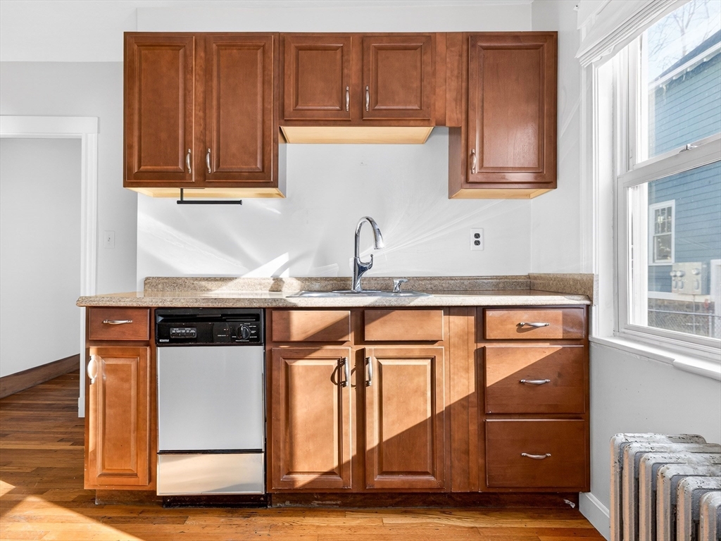 104 Greaton Road Boston, MA 02132 - Photo 9 of 42 a kitchen with stainless steel appliances granite countertop a refrigerator and cabinets