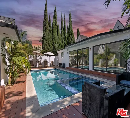 a view of a house with backyard and sitting area