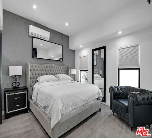 a bedroom with a bed and a couch