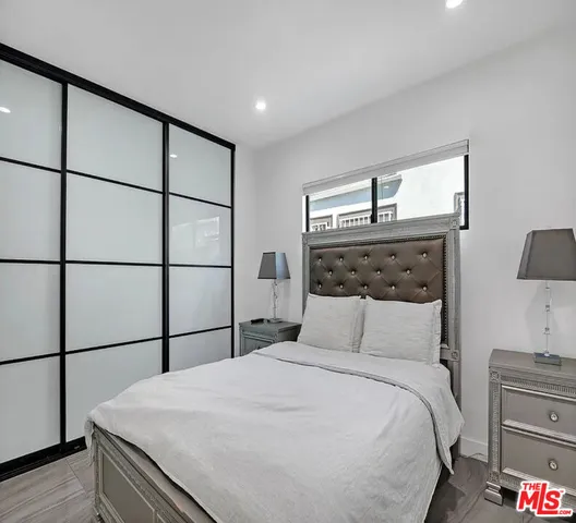 a bedroom with a bed and a night stand