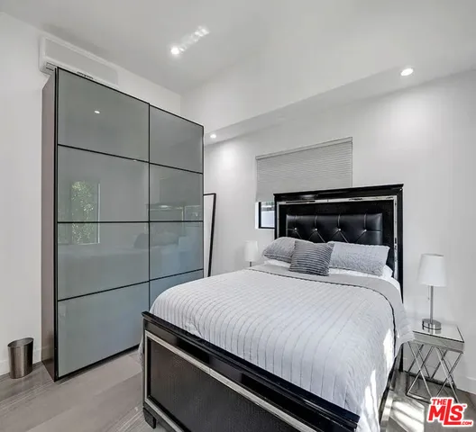 a bedroom with a bed and a dresser