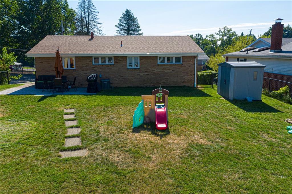 40 Highbury Road Cheswick, PA 15024 - Photo 21 of 25 REAR VIEW OF THIS SPLIT ENTRY. REMEMBER TOO THERE ARE TWO STORAGE SHEDS AND THE YARD IS FENCED.