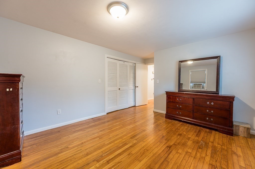 80 Pepper Road Fitchburg, MA 01420 - Photo 24 of 41 an empty room with wooden floor and cabinet