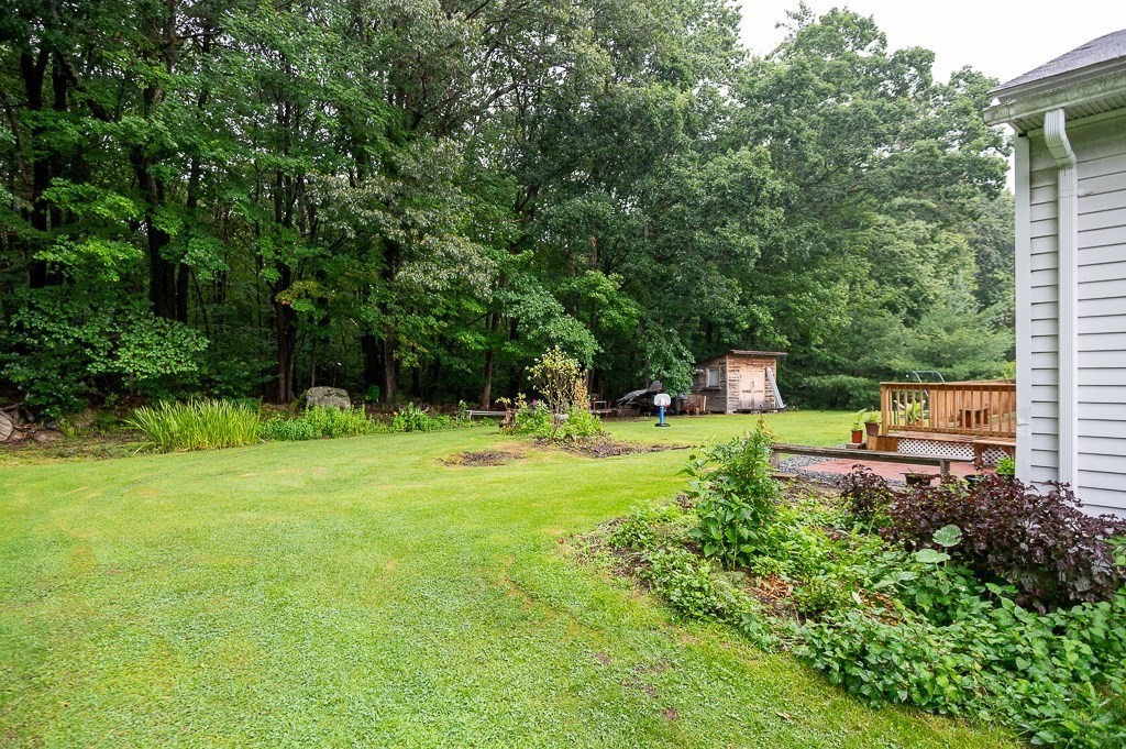 80 Pepper Road Fitchburg, MA 01420 - Photo 5 of 41 a backyard of a house with trees and wooden fence