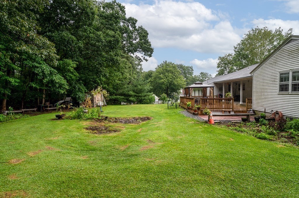 80 Pepper Road Fitchburg, MA 01420 - Photo 7 of 41 a backyard of a house with table and chairs plants and large tree