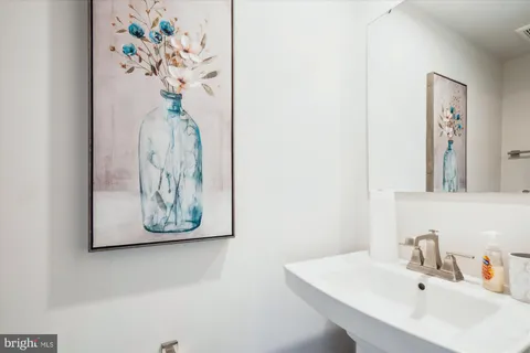 a bathroom with a sink a mirror and vanity