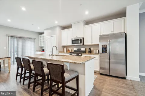 a kitchen with appliances a sink and cabinets