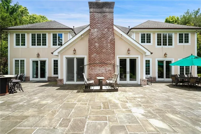 a front view of a house with yard outdoor seating and barbeque oven