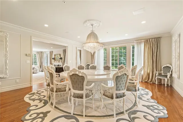 a view of a dining room with furniture wooden floor and chandelier