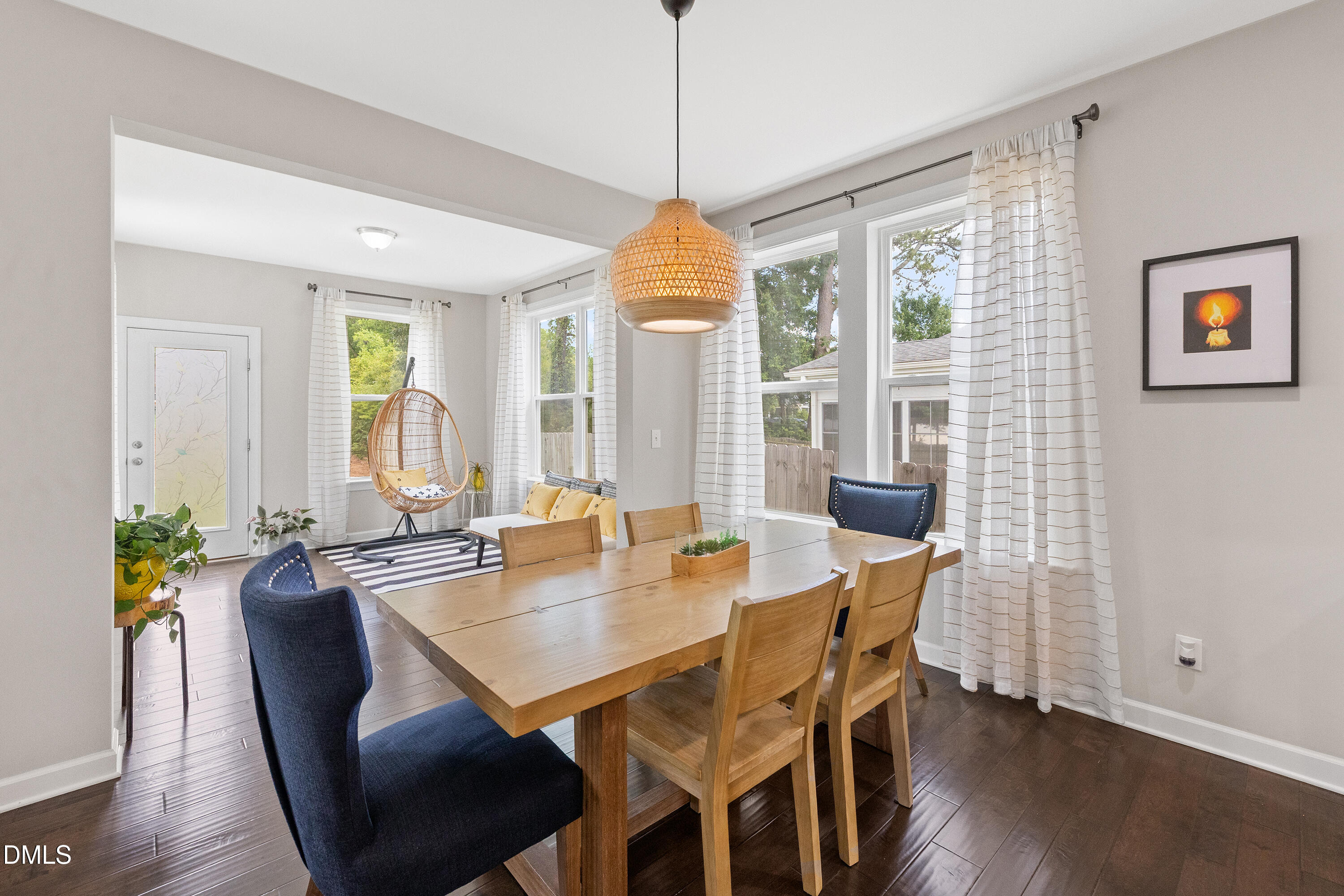 8059 Gilano Drive Raleigh, NC 27603 - Photo 5 of 43 a dining room with furniture a chandelier and wooden floor