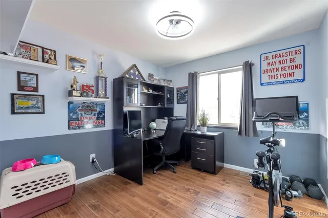 a view of a workspace with furniture and a window