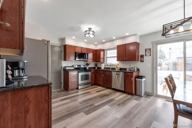 a kitchen with stainless steel appliances granite countertop a refrigerator stove and oven