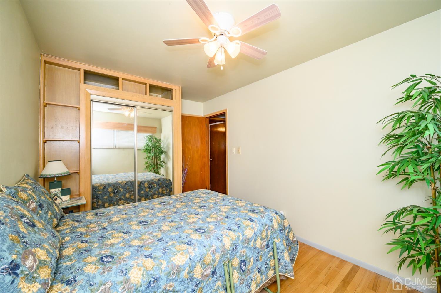 9 Brandeis Road Old Bridge, NJ 08859 - Photo 22 of 45 a bedroom with a bed and a potted plant