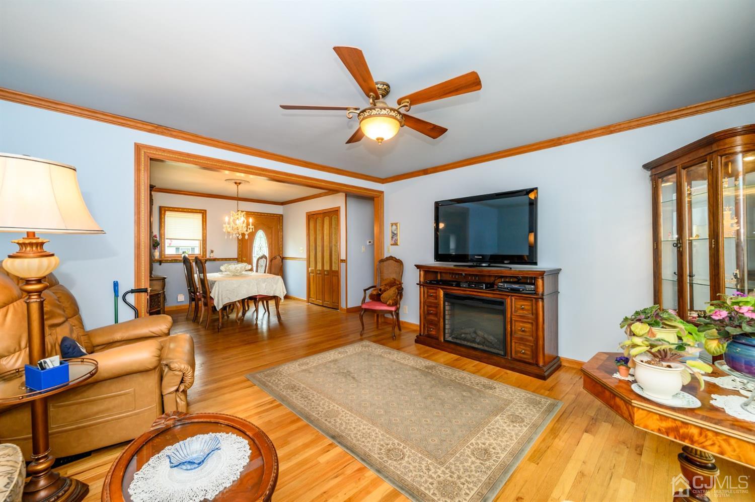 9 Brandeis Road Old Bridge, NJ 08859 - Photo 8 of 45 a living room with furniture and a flat screen tv