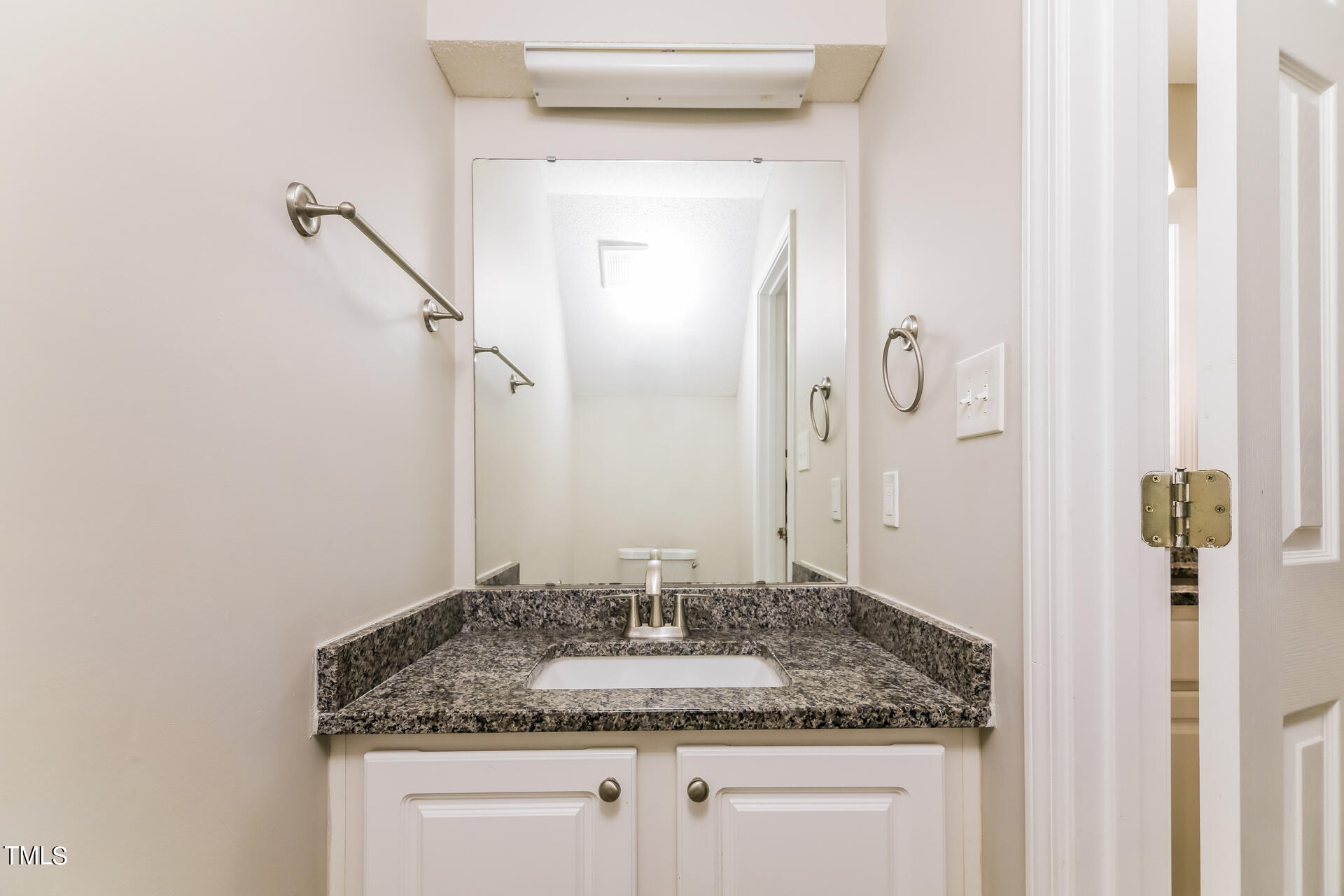 4404 Windsock Lane Raleigh, NC 27616 - Photo 13 of 15 a bathroom with a granite countertop sink and a mirror
