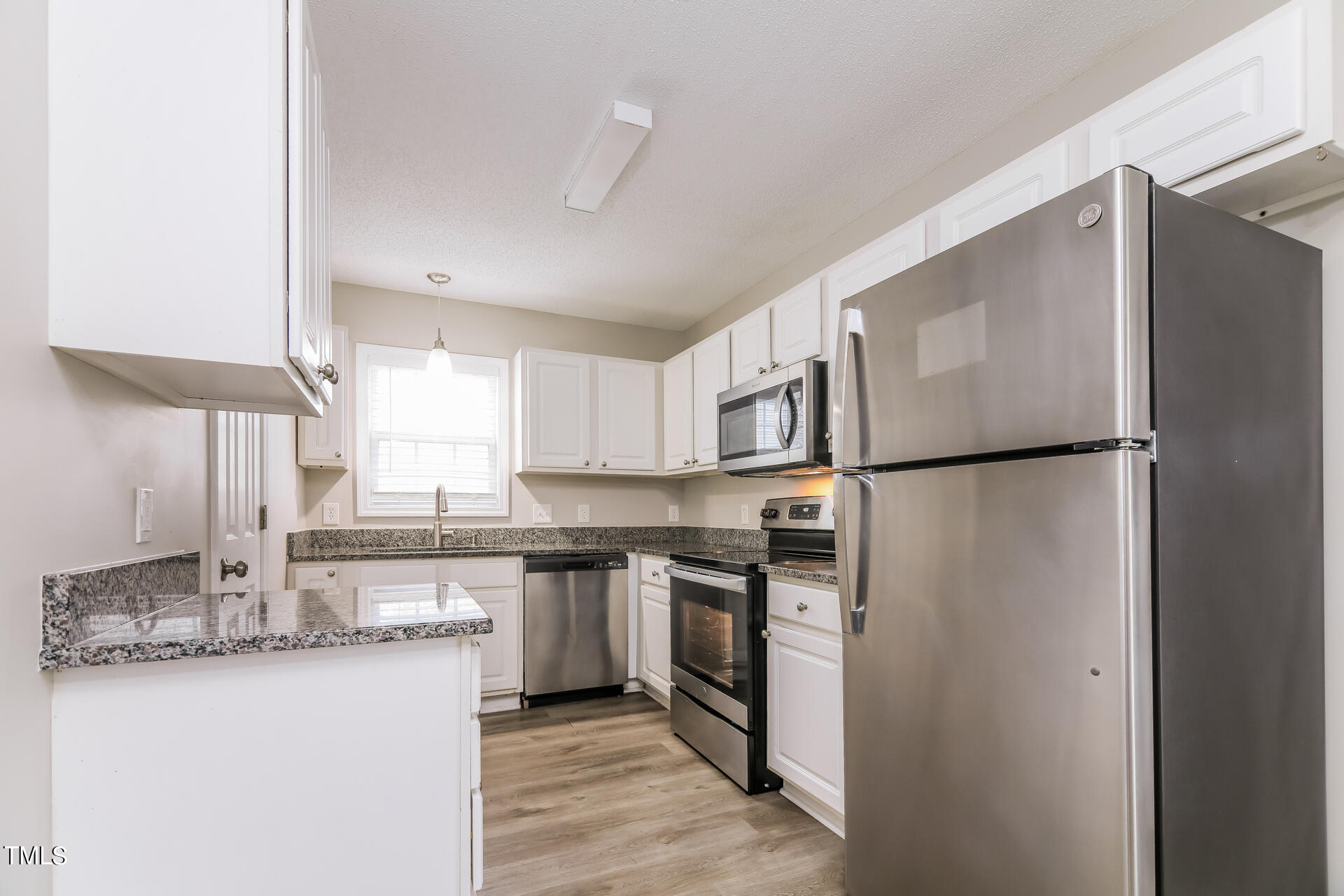 4404 Windsock Lane Raleigh, NC 27616 - Photo 5 of 15 a kitchen with stainless steel appliances granite countertop a refrigerator a sink and a stove