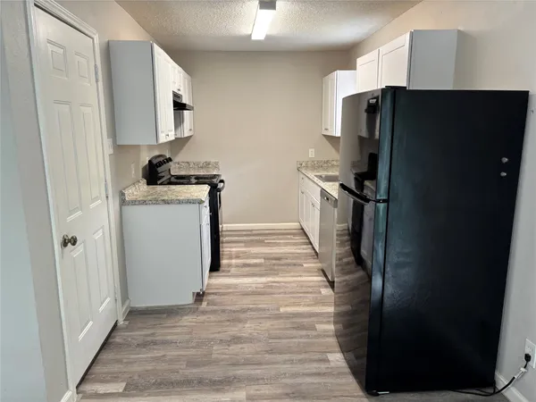 a kitchen with a refrigerator and a stove
