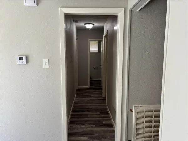 a view of room with wooden floor