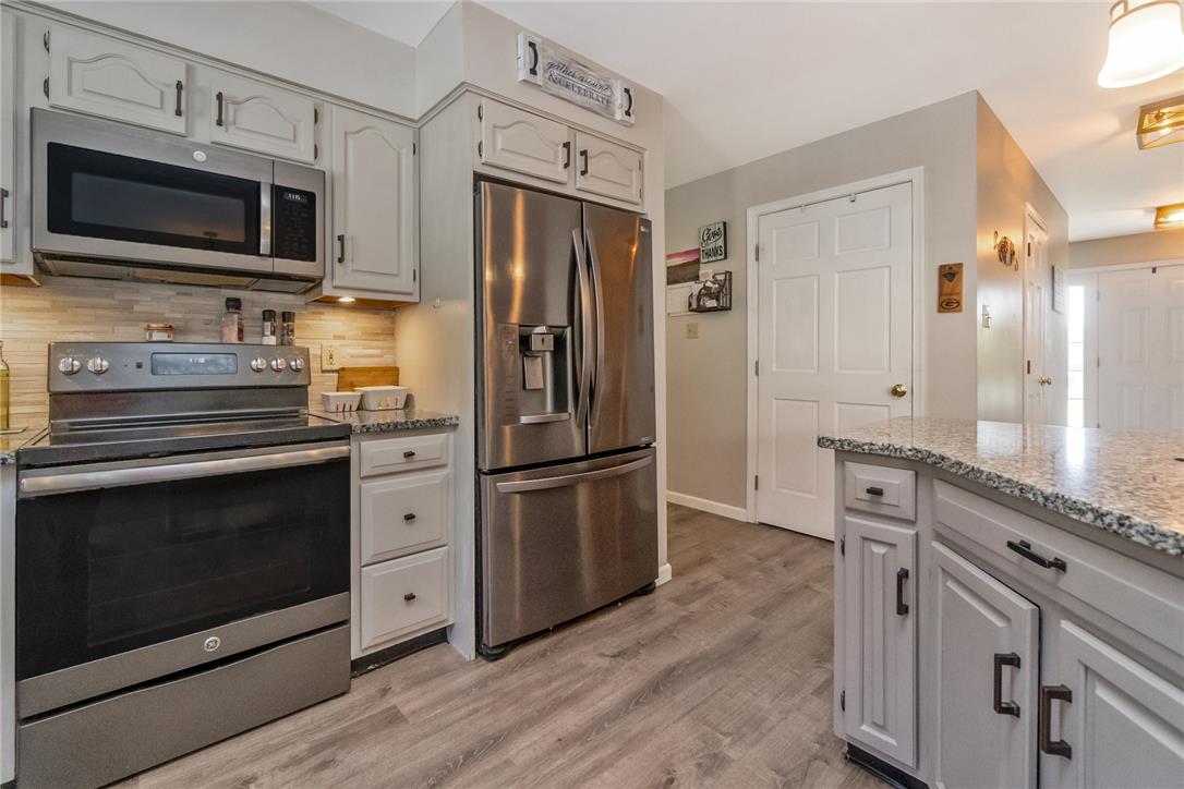 9461 Red Road Kempton, PA 19529 - Photo 9 of 55 A well-appointed kitchen showcasing durable wood-look flooring and ample cabinet storage.