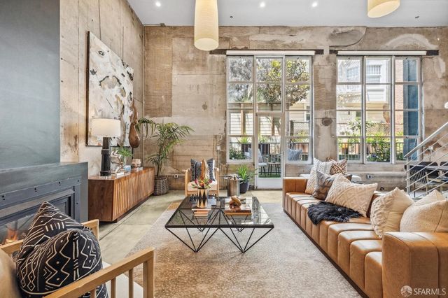 a living room with furniture and a floor to ceiling window